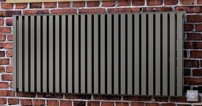 Designer electric radiator installed on a brick-designed wall.